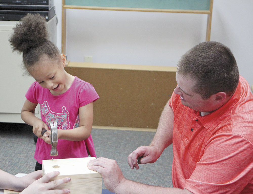 Hammering in the morning: High-schoolers help kindergartners build birdhouses