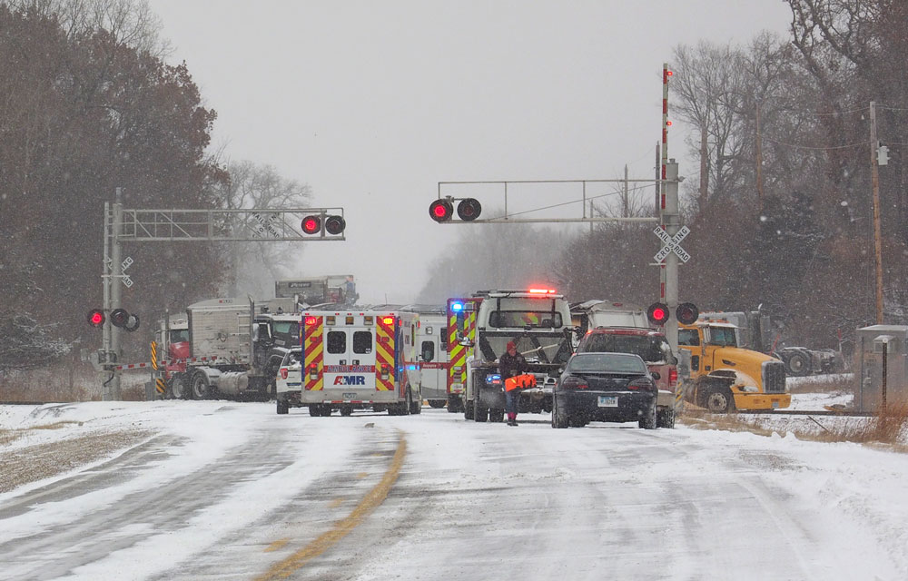 Four-semi pileup north of Floyd including collision with moving train causes minor injuries