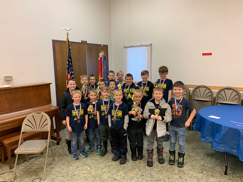 Charles City Cub Scouts cross the finish line with their Pinewood Derby cars