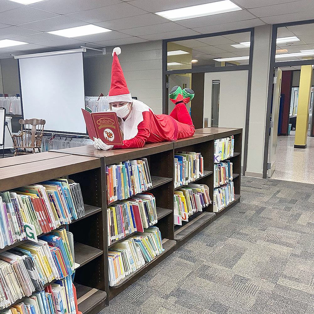Living elf wanders the shelves at Washington Elementary
