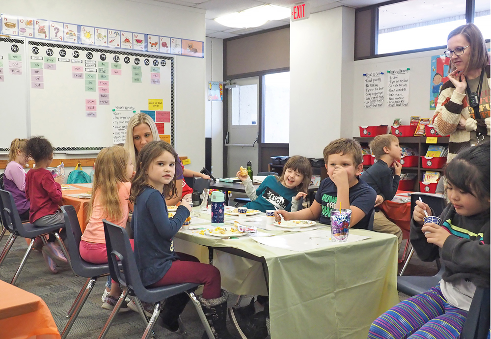 Washington Elementary first-graders help provide then enjoy traditional Thanksgiving meal