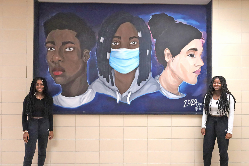 Charles City High School senior art sisters showcase new mural