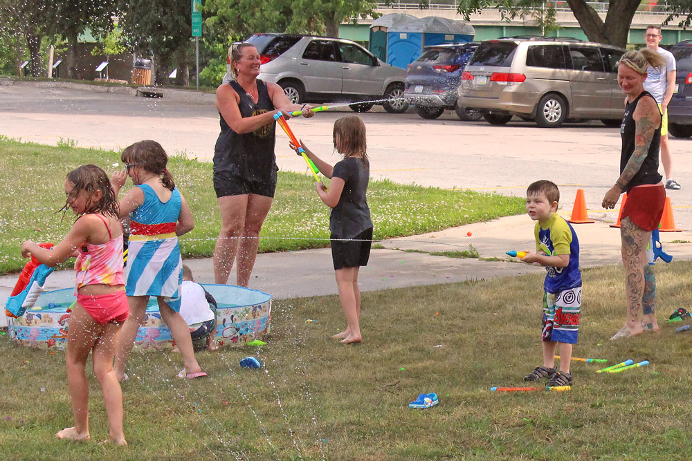 Kids cool off at Charles City library water gun fight