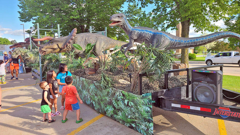 Dinos drop by Charles City for cookie promotion