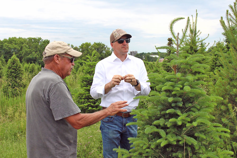 Ag Secretary Naig trims Christmas tree during two-stop visit to Nashua