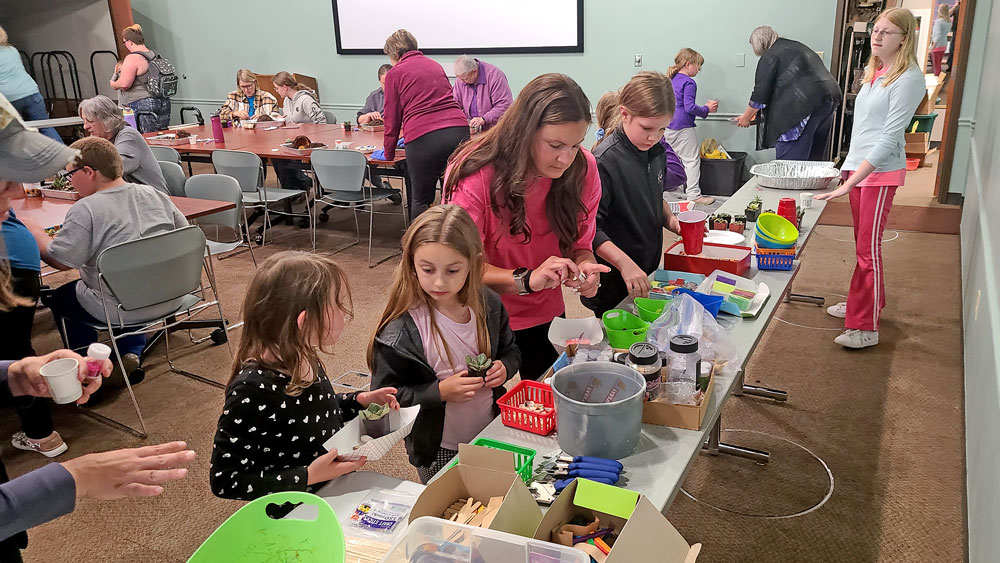 Families make fairy caves during Library’s summer programming